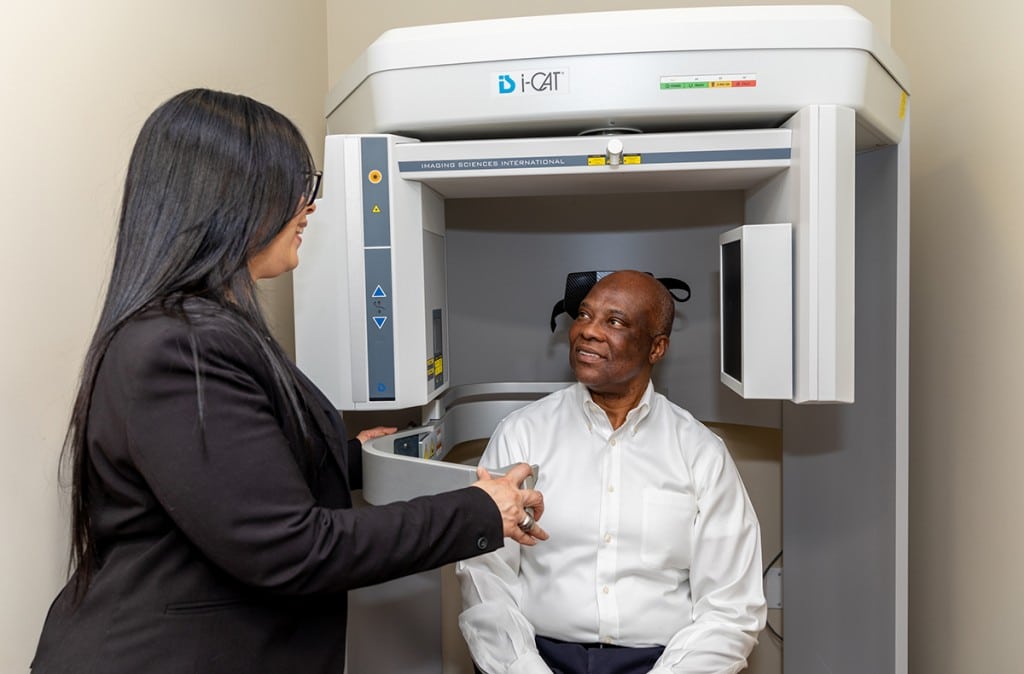 patient looking for permanent tmj solution sits in a I-CAT scan machine