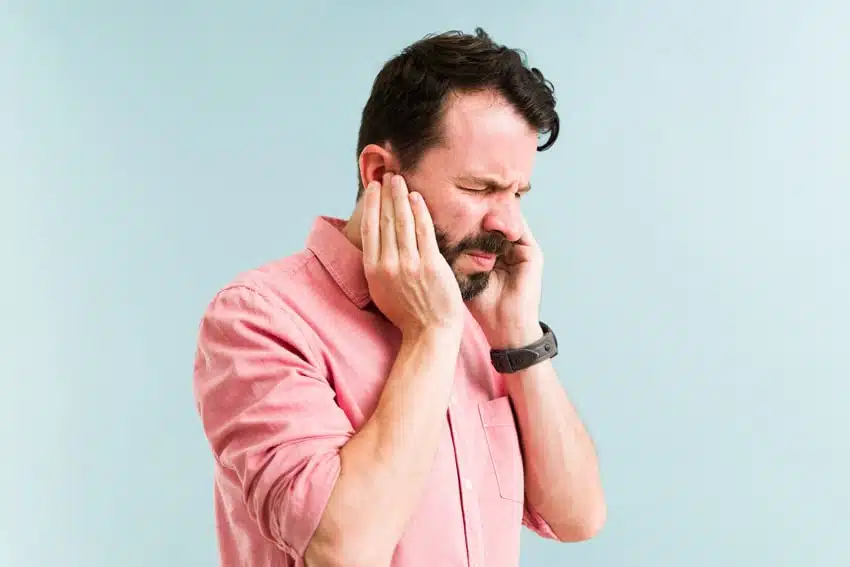 adult man holding his face in pain