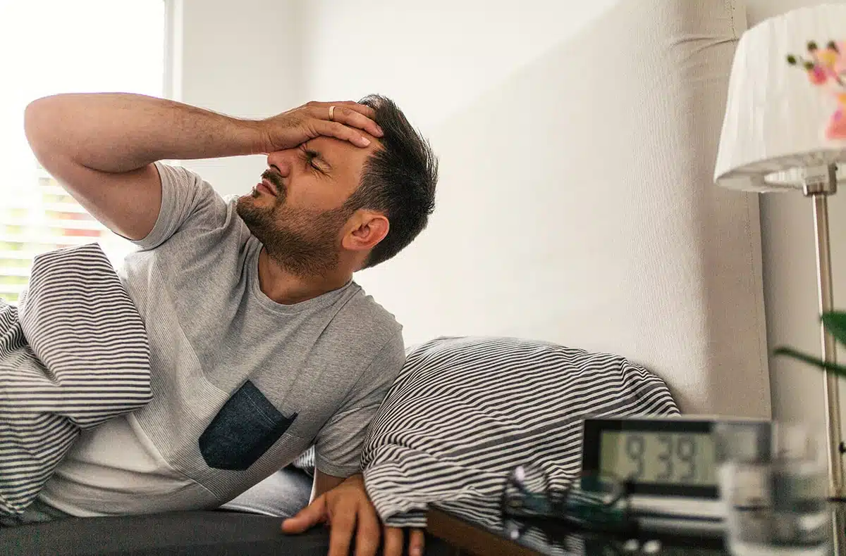 man suffering from a morning, sleep apnea headache